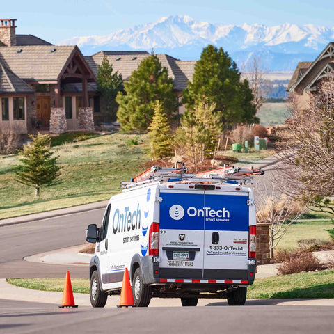 OnTech technician diagnosing Wi-Fi problems in a home